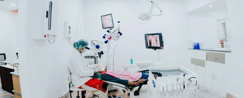 A lady dentist performing a procedure on a patient in her clinic.